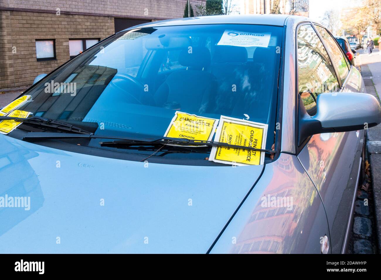 Multiple Penalty Charge Notice PCN stuck on a car front window in Croydon Council operated pay and display roadside parking Stock Photo