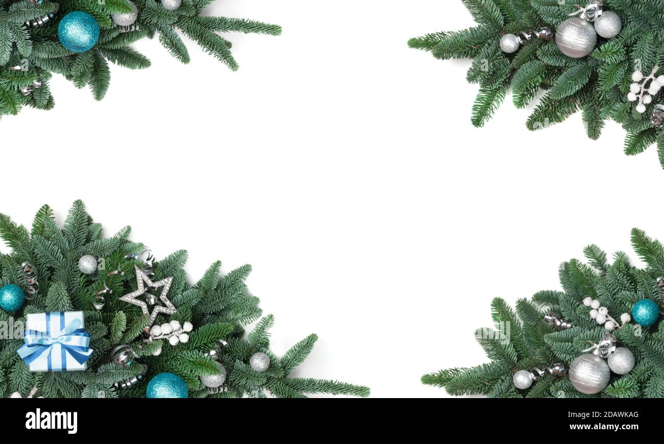 Christmas design element of noble fir tree branches and silver baubles isolated on white background Stock Photo