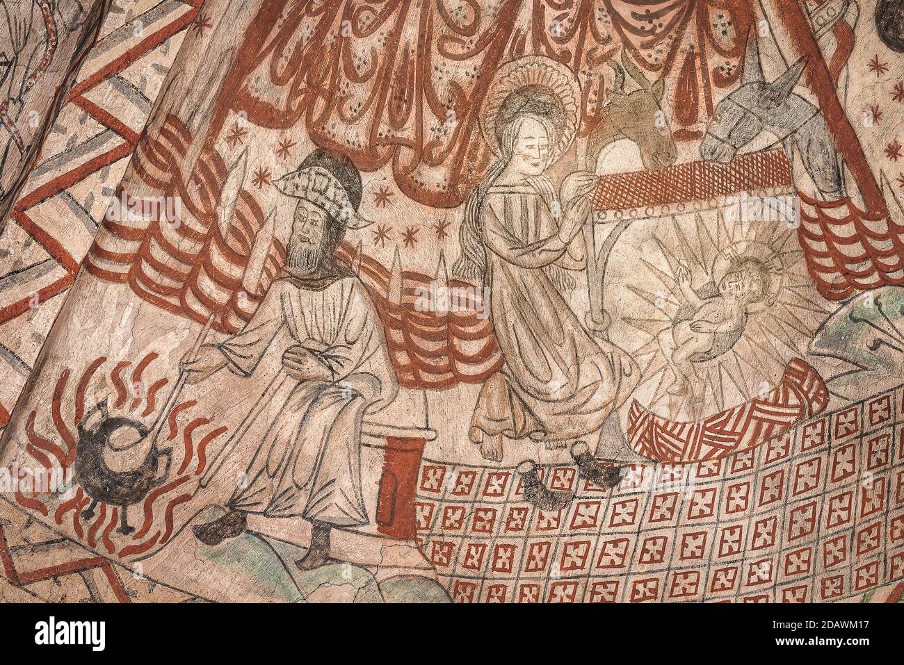 Christmas in the stable. Mary and the boychild on the ground in a shining radiance and Joseph cooking porridge, Wall-painting in Tuse church, Denmark, Stock Photo