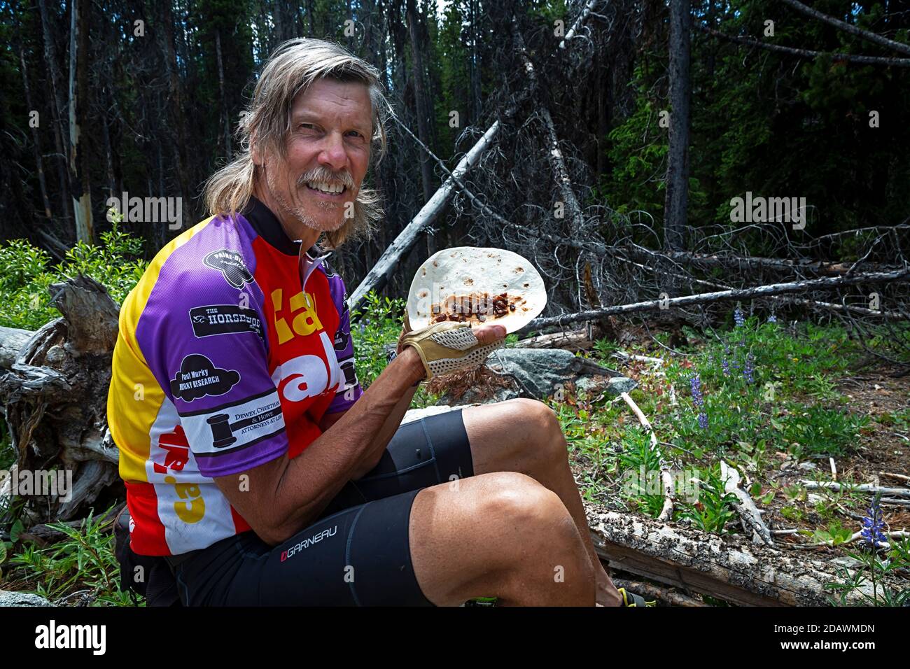 WA18097-00...WASHINGTON - Tom Kirkendall showing off a peanut butter and raisin tortilla, a high energy roll-up for lunch. Stock Photo