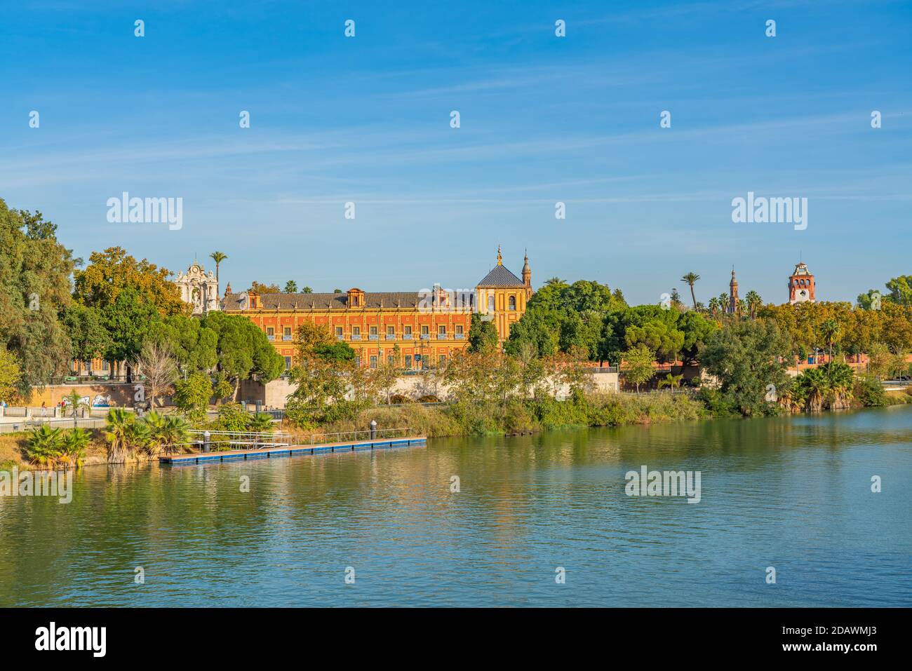 Historical Palacio de San Telmo in Baroque architecture on the green embankment of Guadalquivir river in Seville, Andalusia, Spain Stock Photo