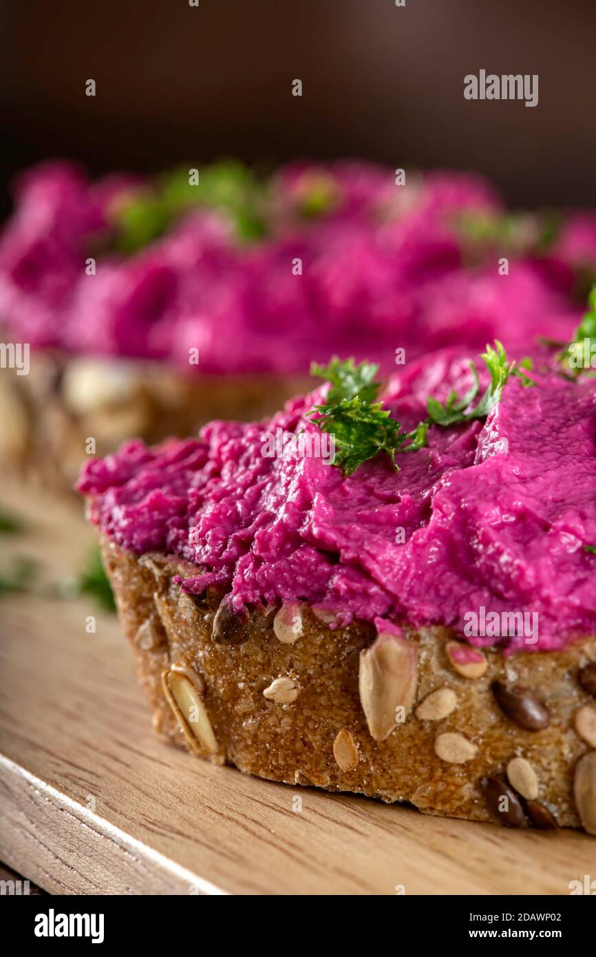 Goat cream cheese mixed with beet spreaded on bread Stock Photo