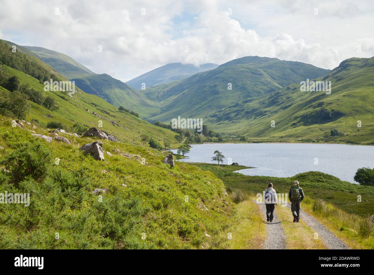 Two walkers heading towards Loch na Leitreach and the Hill An Socach, Scotland. Stock Photo