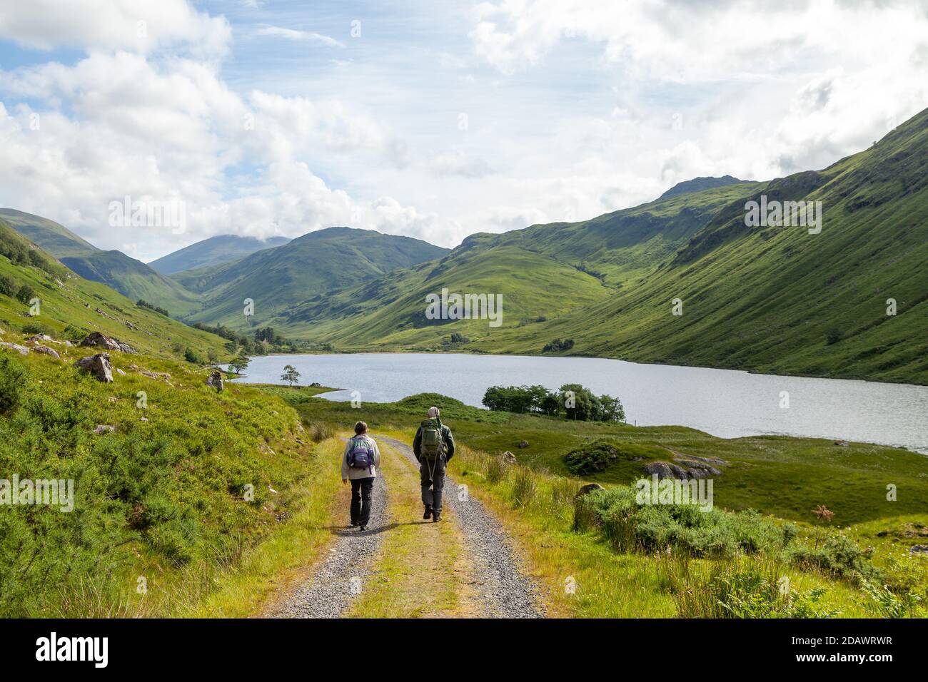 Two walkers heading towards Loch na Leitreach and the Hill An Socach, Scotland. Stock Photo