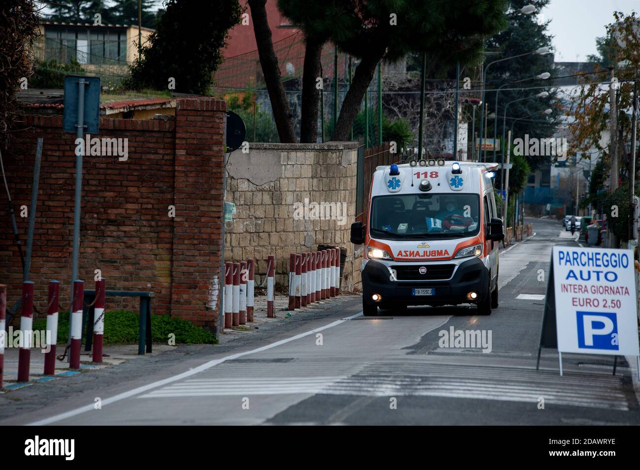 An ambulance carrying a covid19 suspected patient arrives at Cotugno Hospital.With the high spread of Covid-19 pandemic in Campania region, assistance for suspected cases of covid 19 at the hospitals in Naples occur at the parking areas with checking and oxygen supply. Stock Photo
