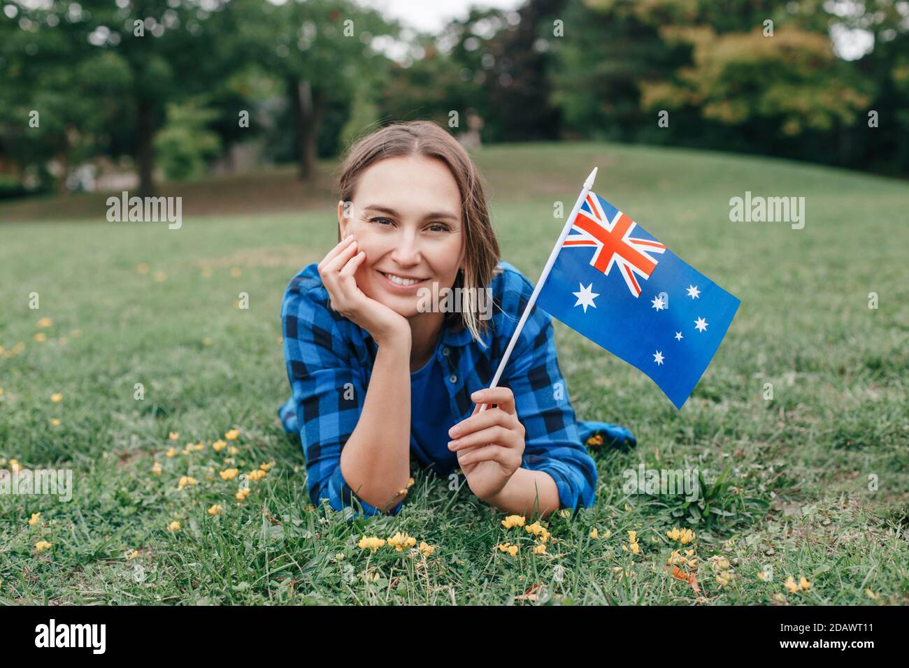 Happy Caucasian middle age woman waving Australian flag. Smiling proud  citizen lying on green on grass ground in park celebrating Australia Day  holida Stock Photo - Alamy