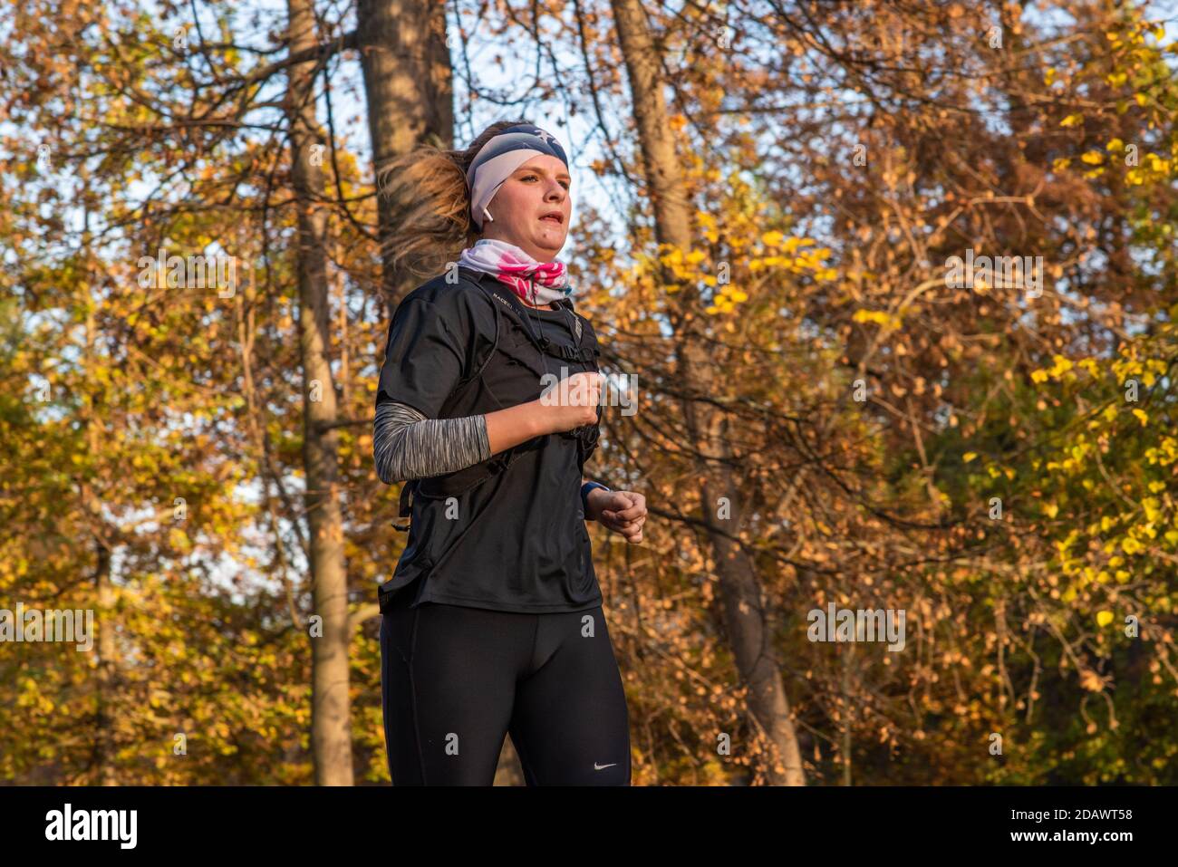 11/14/2020. Park Stromovka. Prague czech Republic. A woman is running in the park on a Sunday winter day. Stock Photo