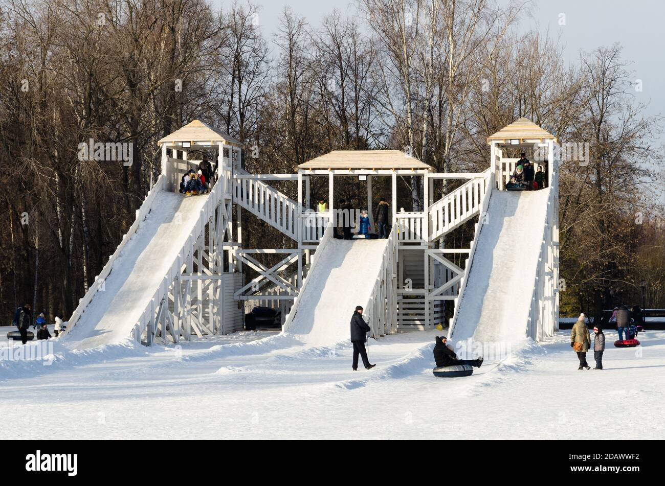 People playing on snow slides in Gorky Park, Kazan, Russia. Stock Photo