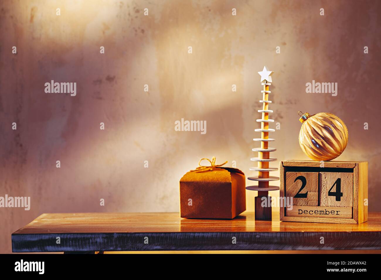 Simple image with christmas tree, gift, ornament and wooden calendar Stock Photo
