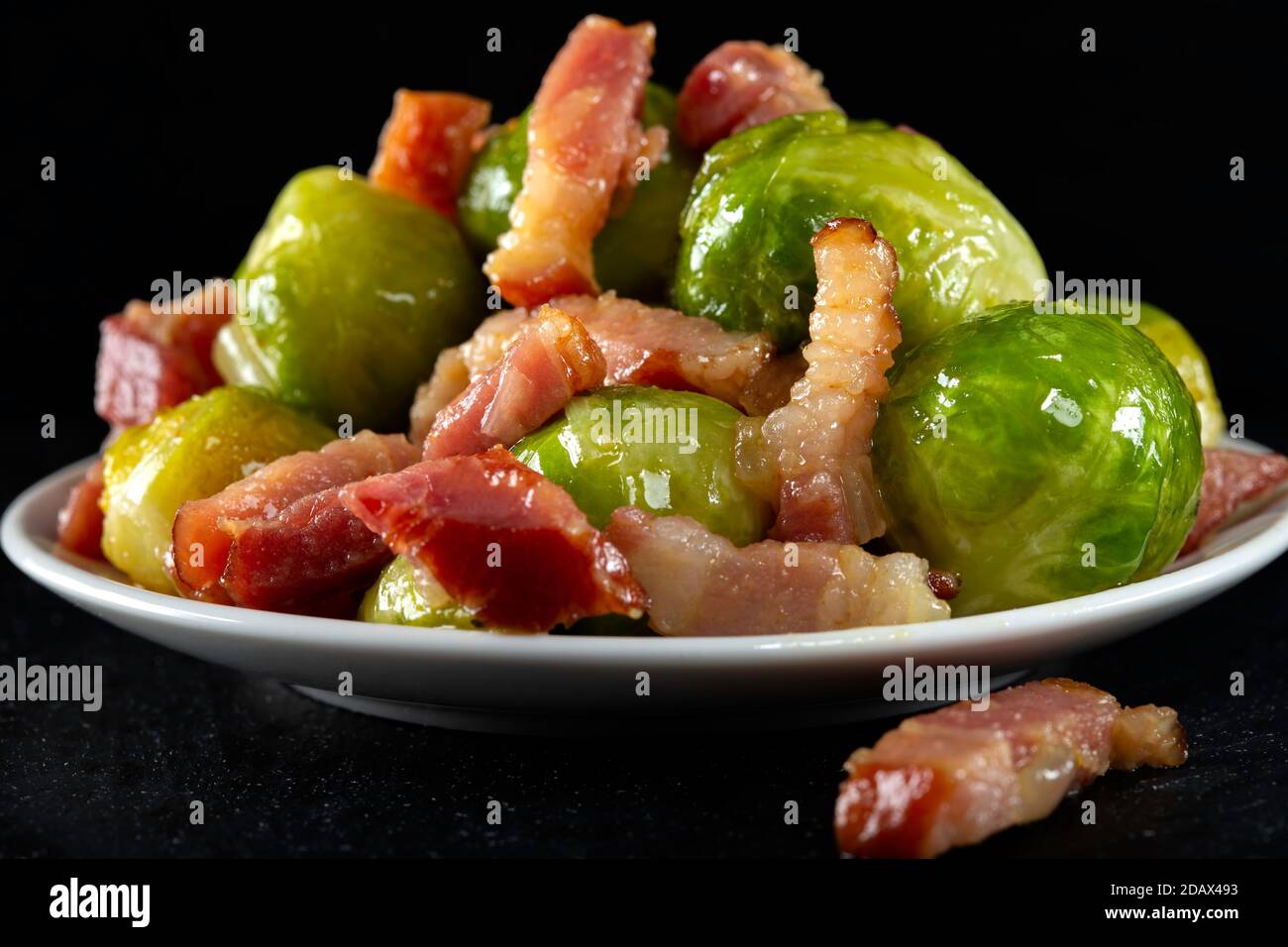 Fried brussels sprouts with bacon on plate Stock Photo
