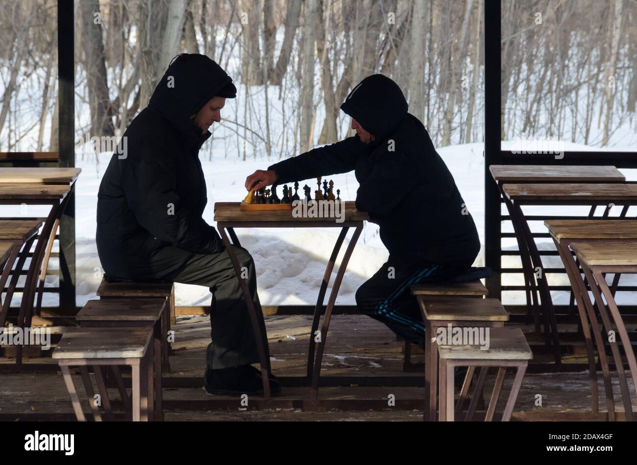 Two men playing chess in the snow in Gorky Park in Kazan, Republic of Tatarstan. Stock Photo