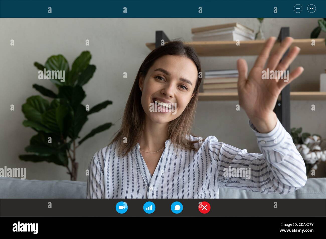 Relaxed smiling young woman making hello gesture starting distant ...