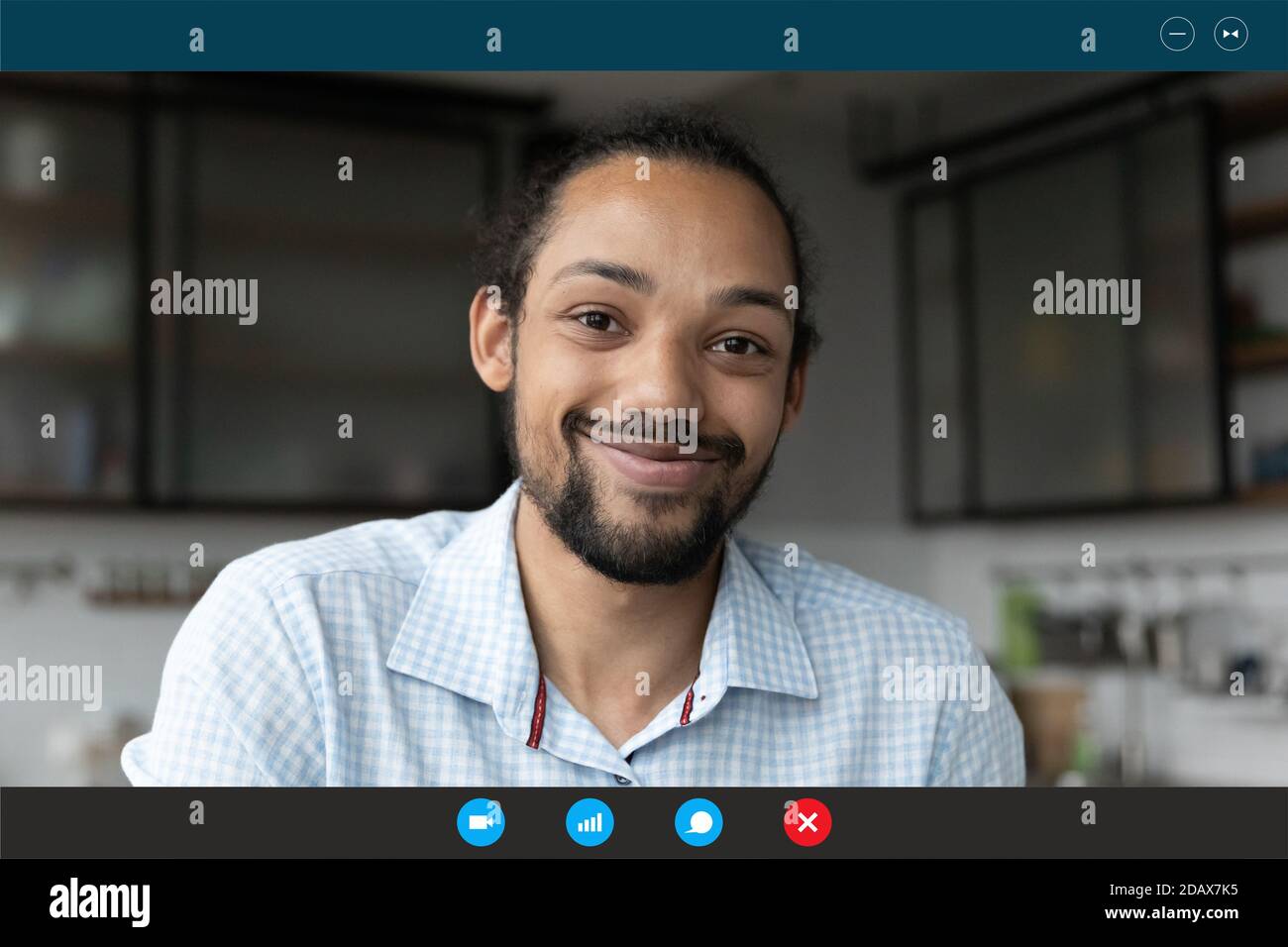 Smiling young african ethnicity guy enjoying distant communication. Stock Photo