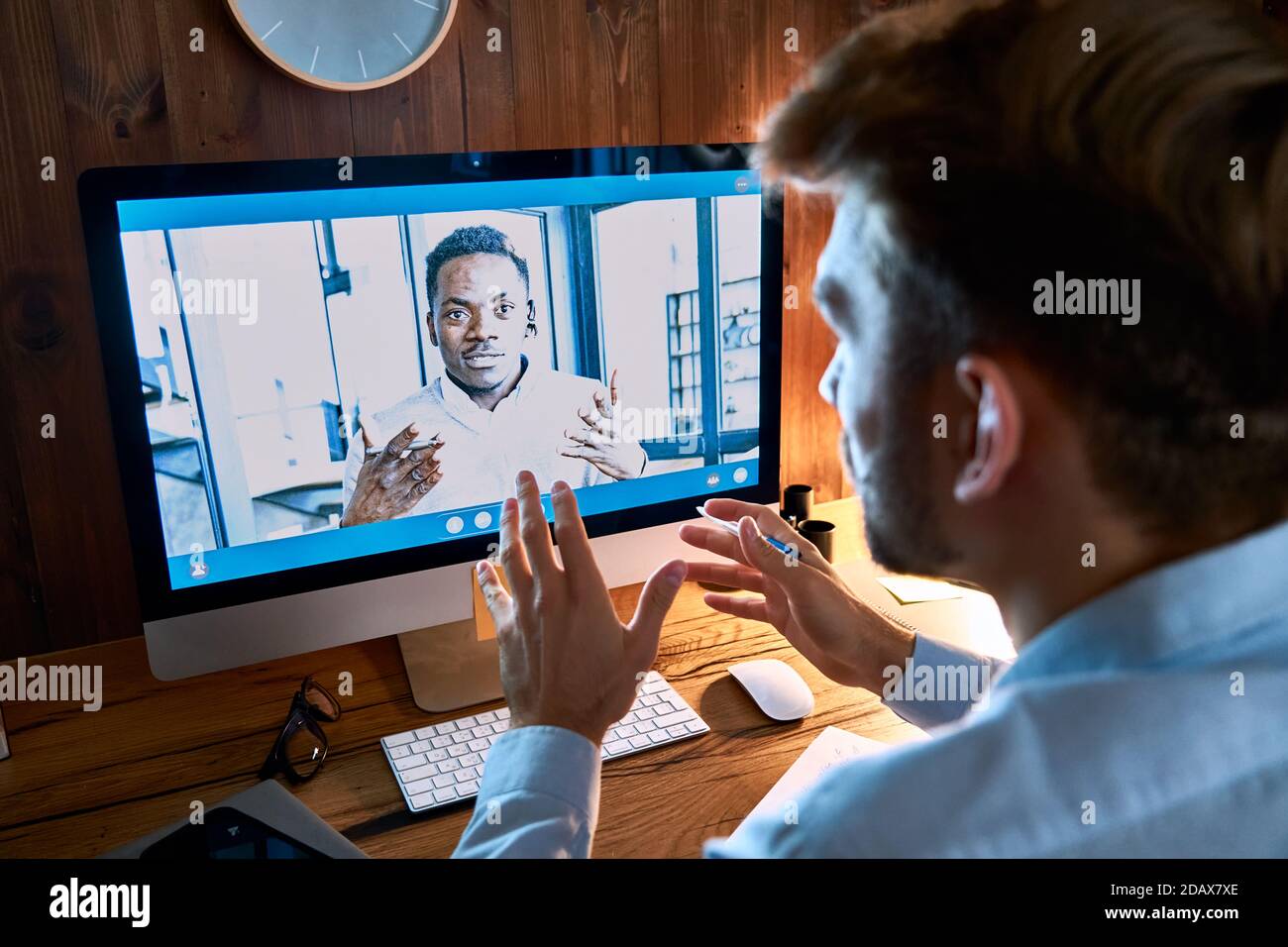 Caucasian business man talking with african partner on video conference call. Stock Photo