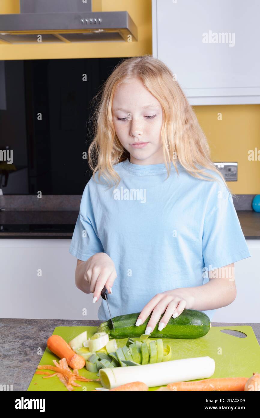 12-year-old girl preparing vegetables in her kitchen Stock Photo - Alamy