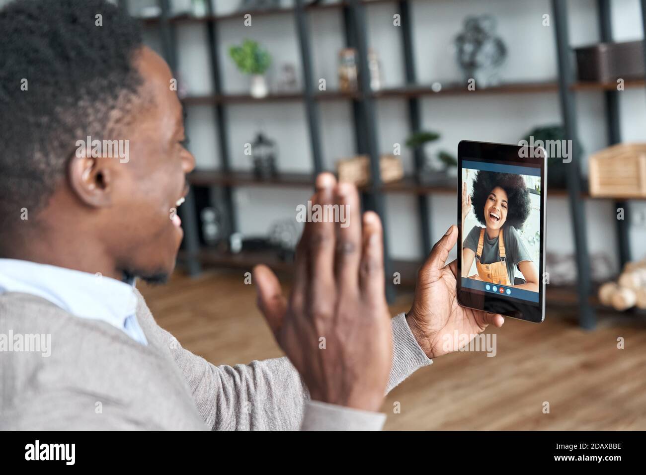 African american man video calling girlfriend on digital tablet. Stock Photo