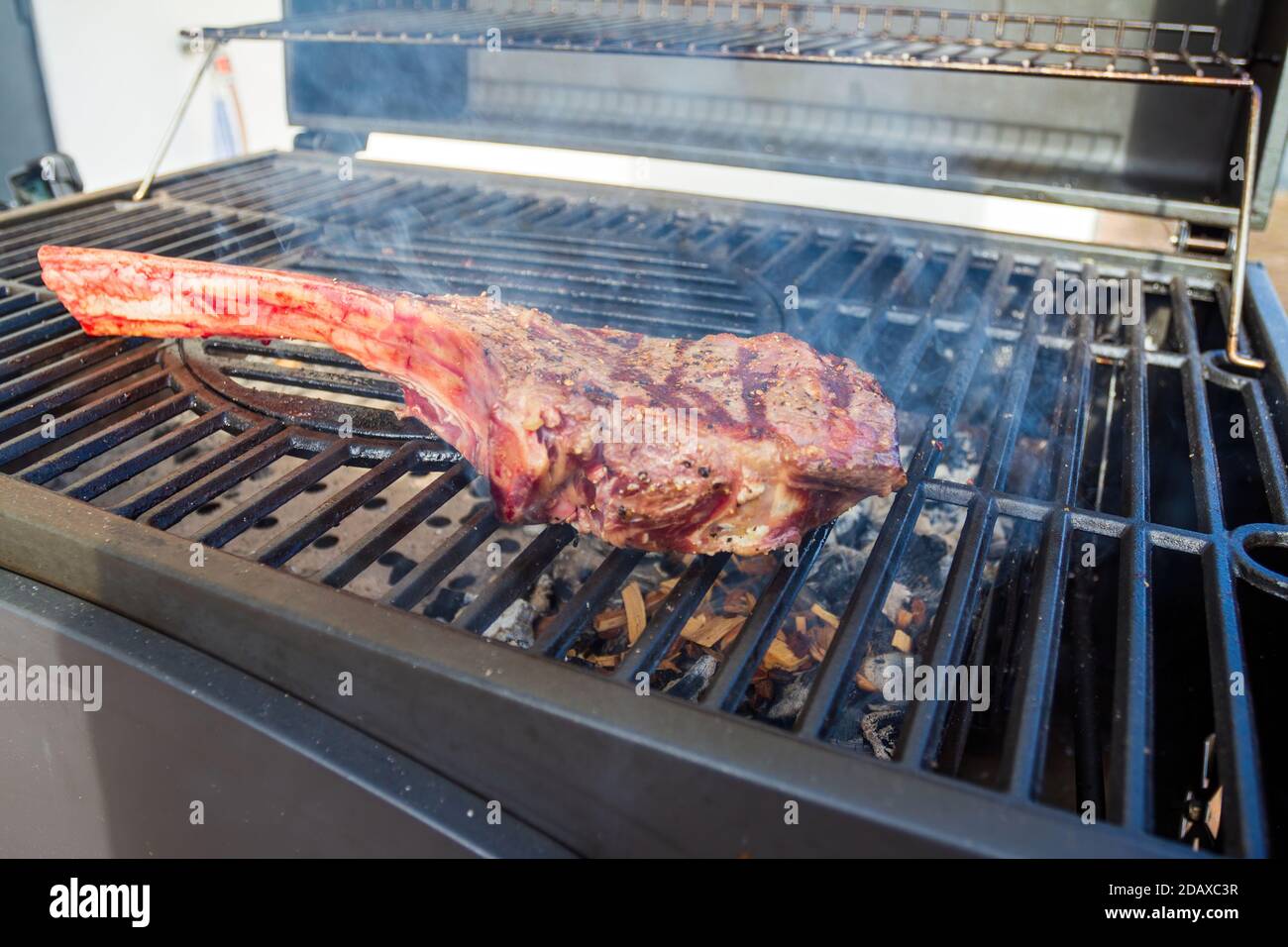 Dry Aged Barbecue Tomahawk Steak on grill Stock Photo