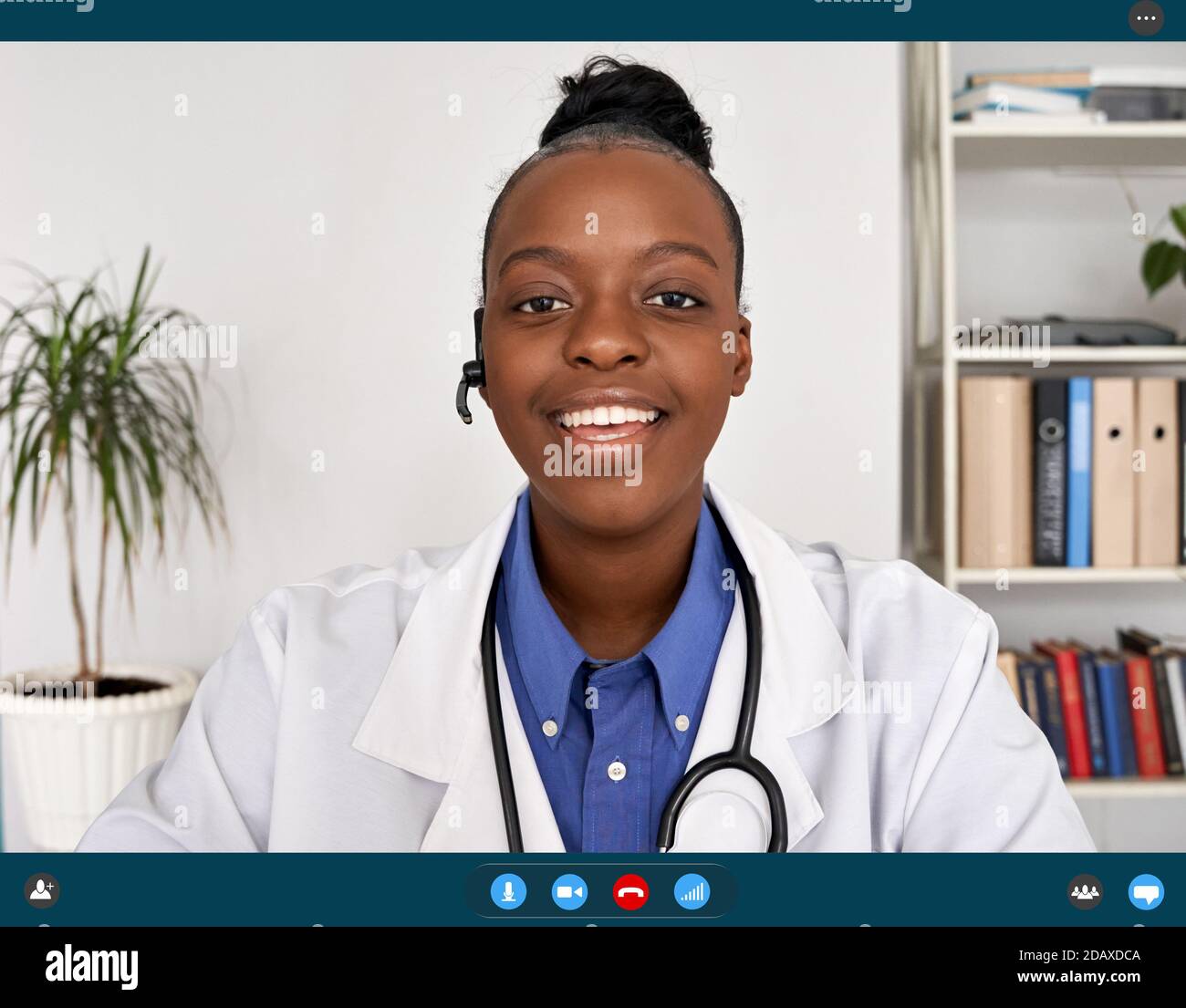 African female doctor talking to web camera, telemedicine video call. Stock Photo