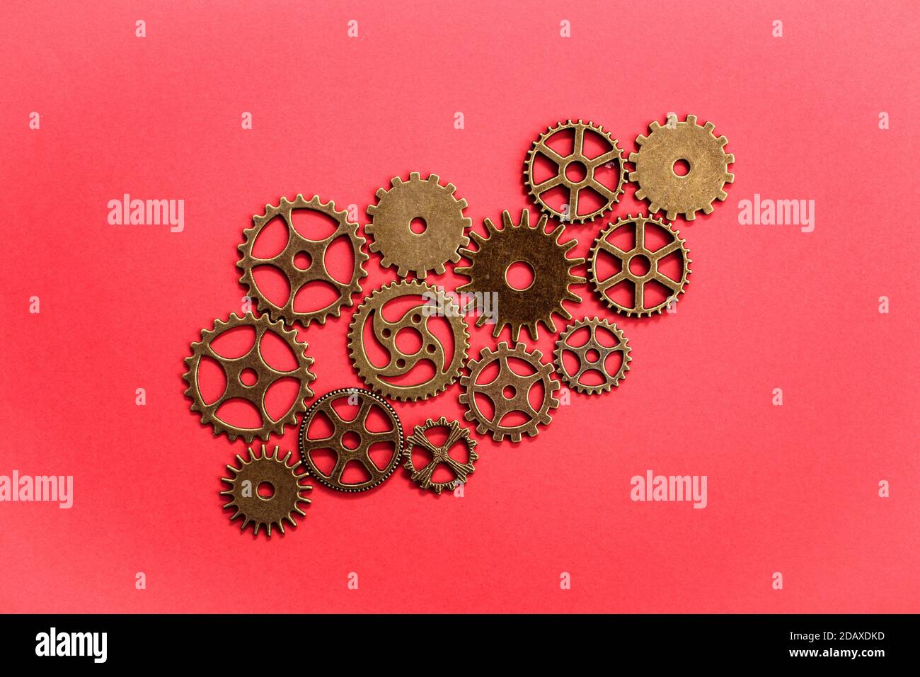 Various gears over red background Stock Photo
