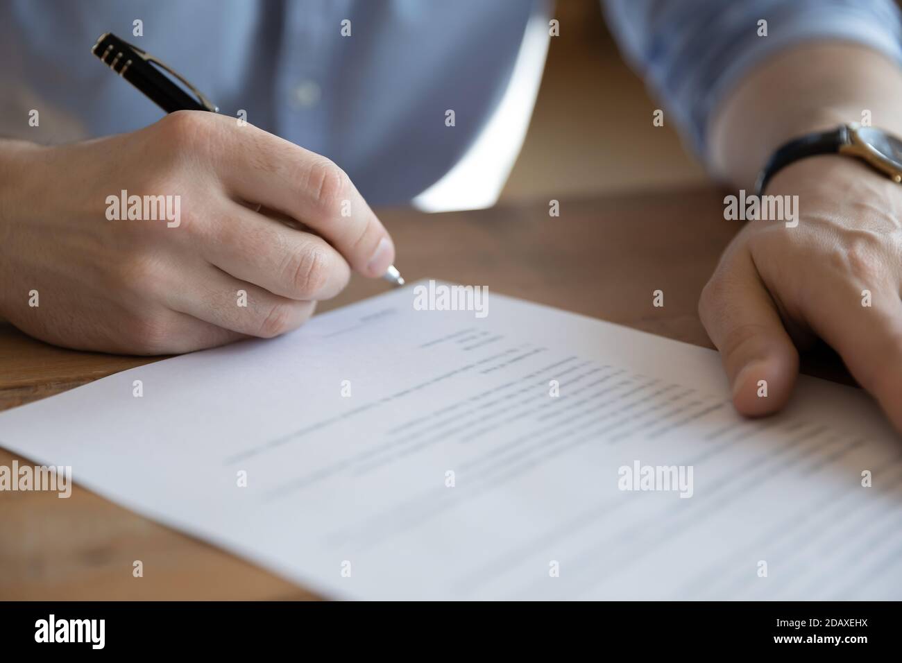 Bank client sitting at table sign loan application, closeup Stock Photo
