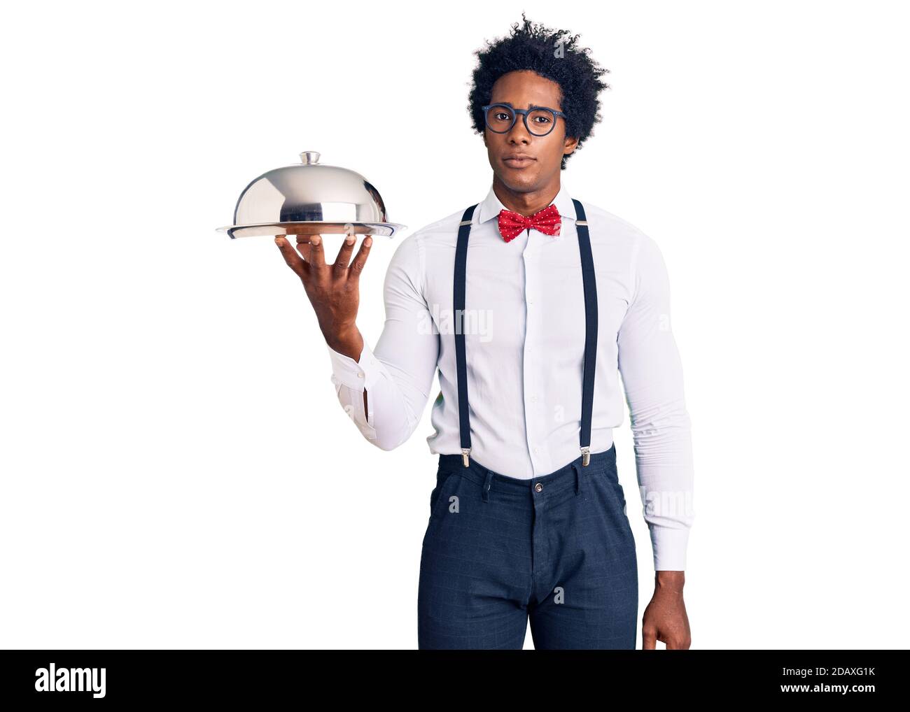 Handsome african american man with afro hair wearing waiter uniform holding  silver tray thinking attitude and sober expression looking self confident  Stock Photo - Alamy