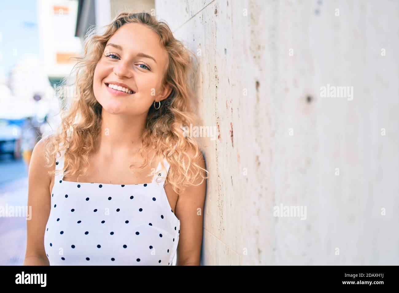 Young beautiful caucasian woman with blond hair smiling happy outdoors ...