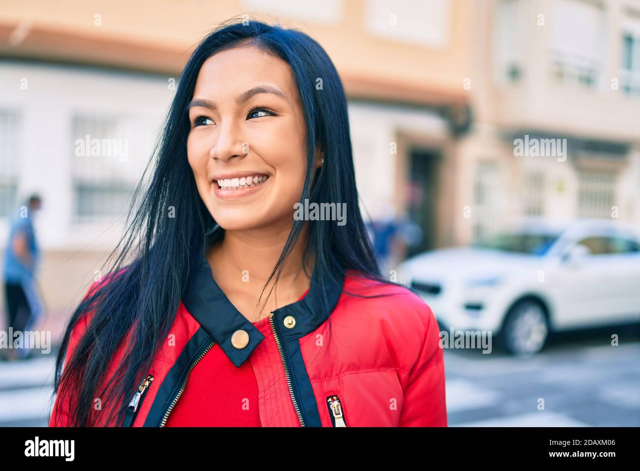 Young latin woman smiling happy walking at the city Stock Photo - Alamy