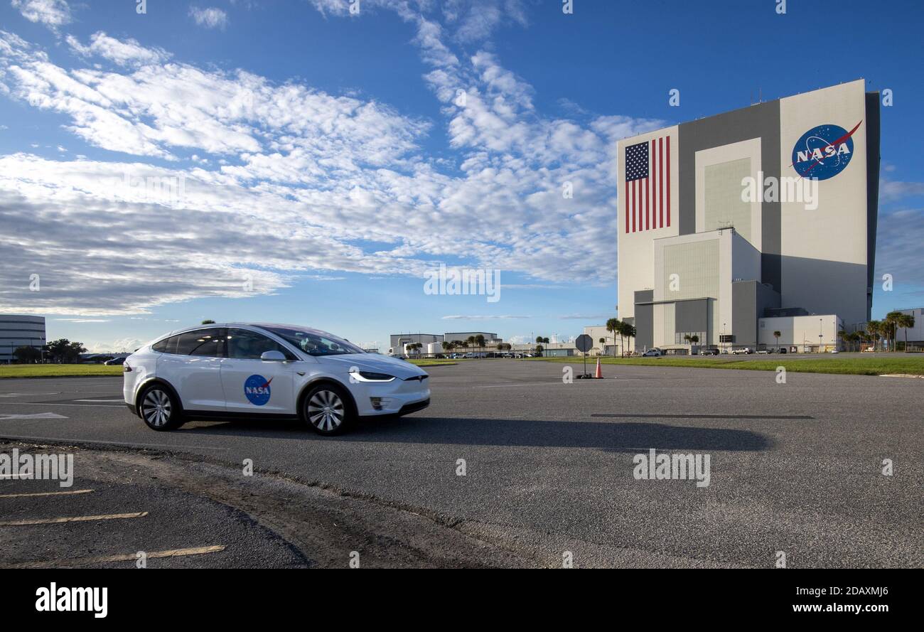 Astronauts ride in several Tesla Model X cars as they travel past the Vehicle Assembly Building (VAB) on their way to board Crew-1 atop a SpaceX Falcon 9 rocket to prepare for launch from Complex 39A at the Kennedy Space Center in Florida on Sunday, November 15, 2020. The Crew Dragon spacecraft is expected to launch in the evening with four astronauts aboard headed for the International Space Station, and is manned by NASA Astronauts, Commander Michael Hopkins, Pilot Victor Glover, Mission Specialist Shannon Walker and Japanese Aerospace Exploration Agency (JAXA) Mission Specialist, Soichi N Stock Photo