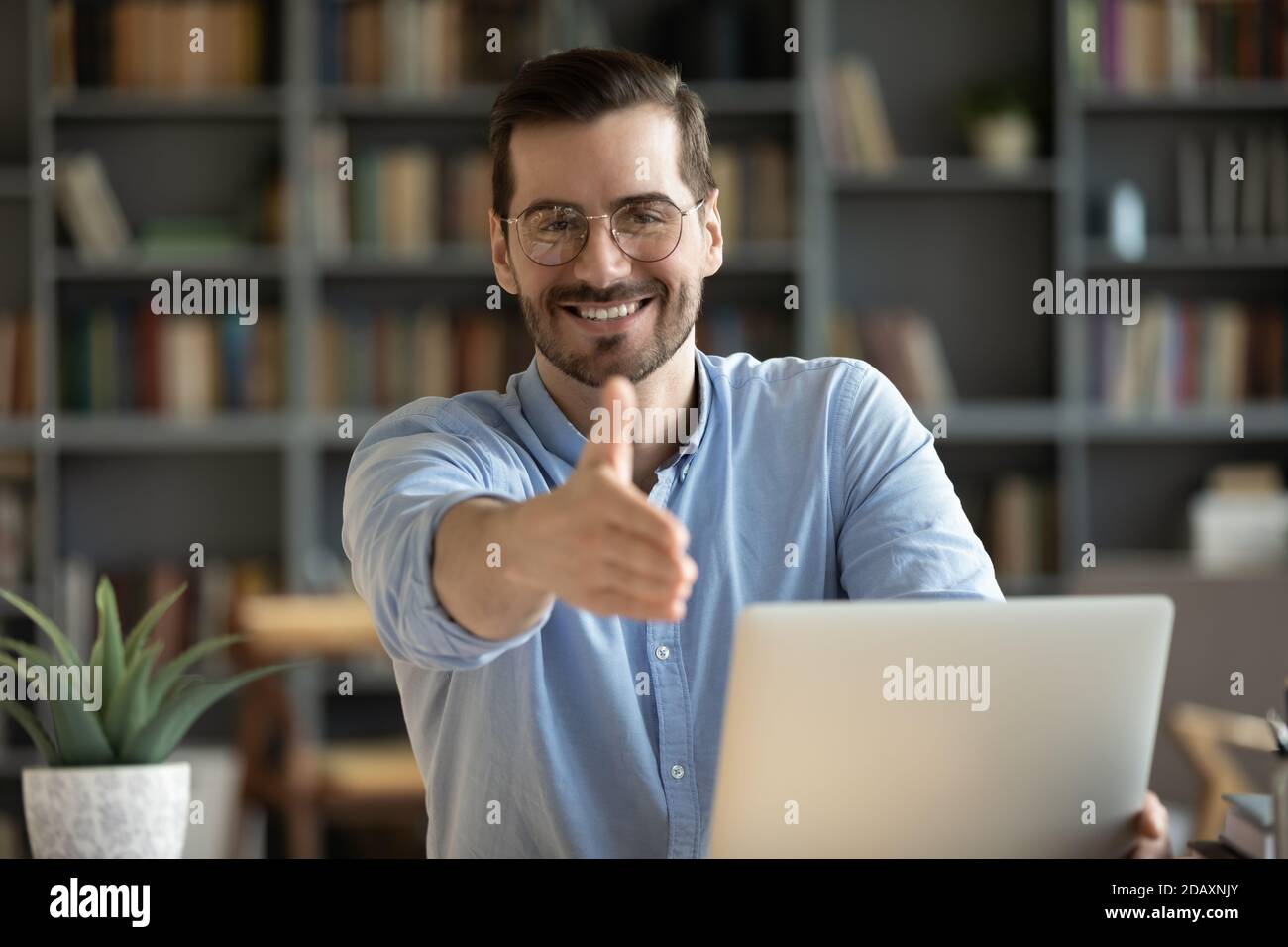 HR agent greeting applicant extend hand for handshake Stock Photo