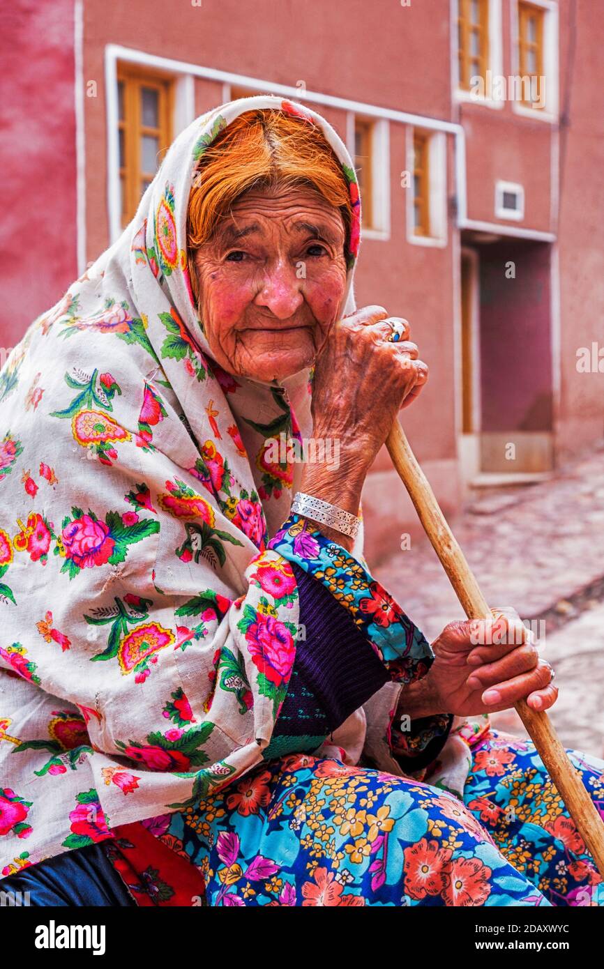 Portrait of old woman in Abyaneh. Abyaneh is a ancient village and Characterized by a peculiar reddish hue. Stock Photo