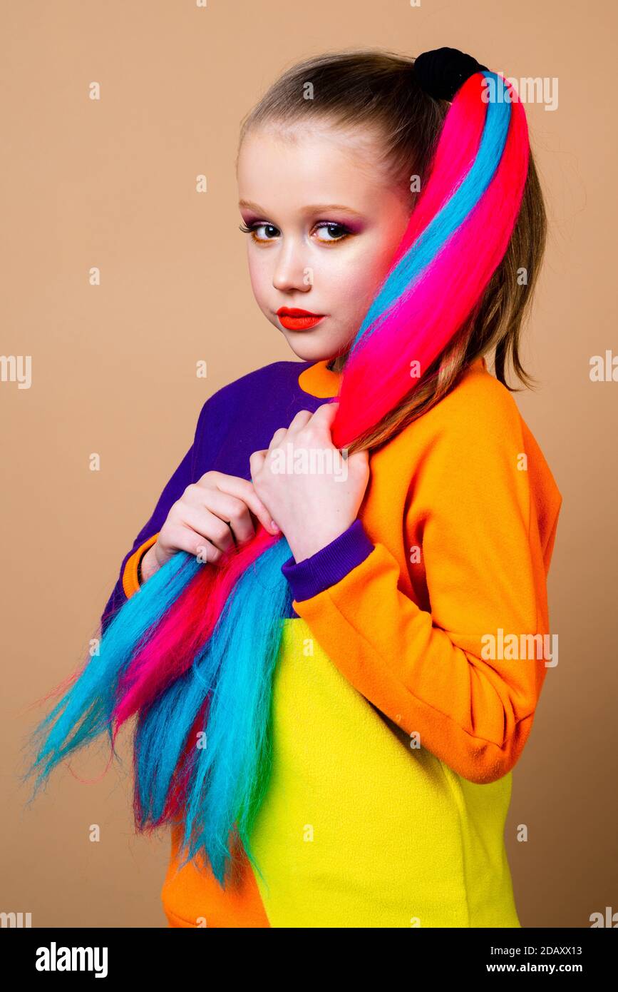 Kids fashion. Colorful child hair. Trendy hairstyle concept. Girl with