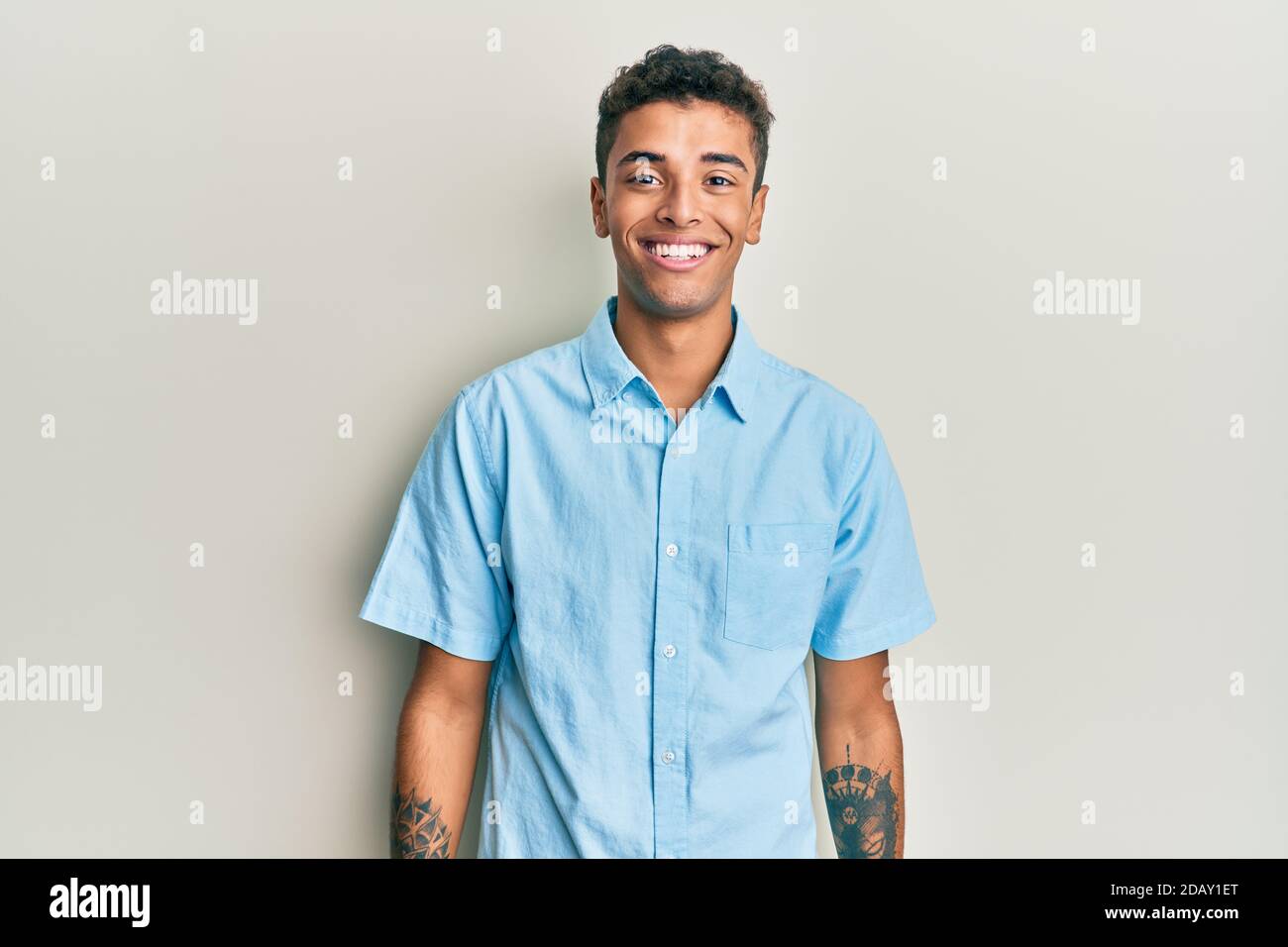 Young handsome african american man wearing casual clothes looking ...