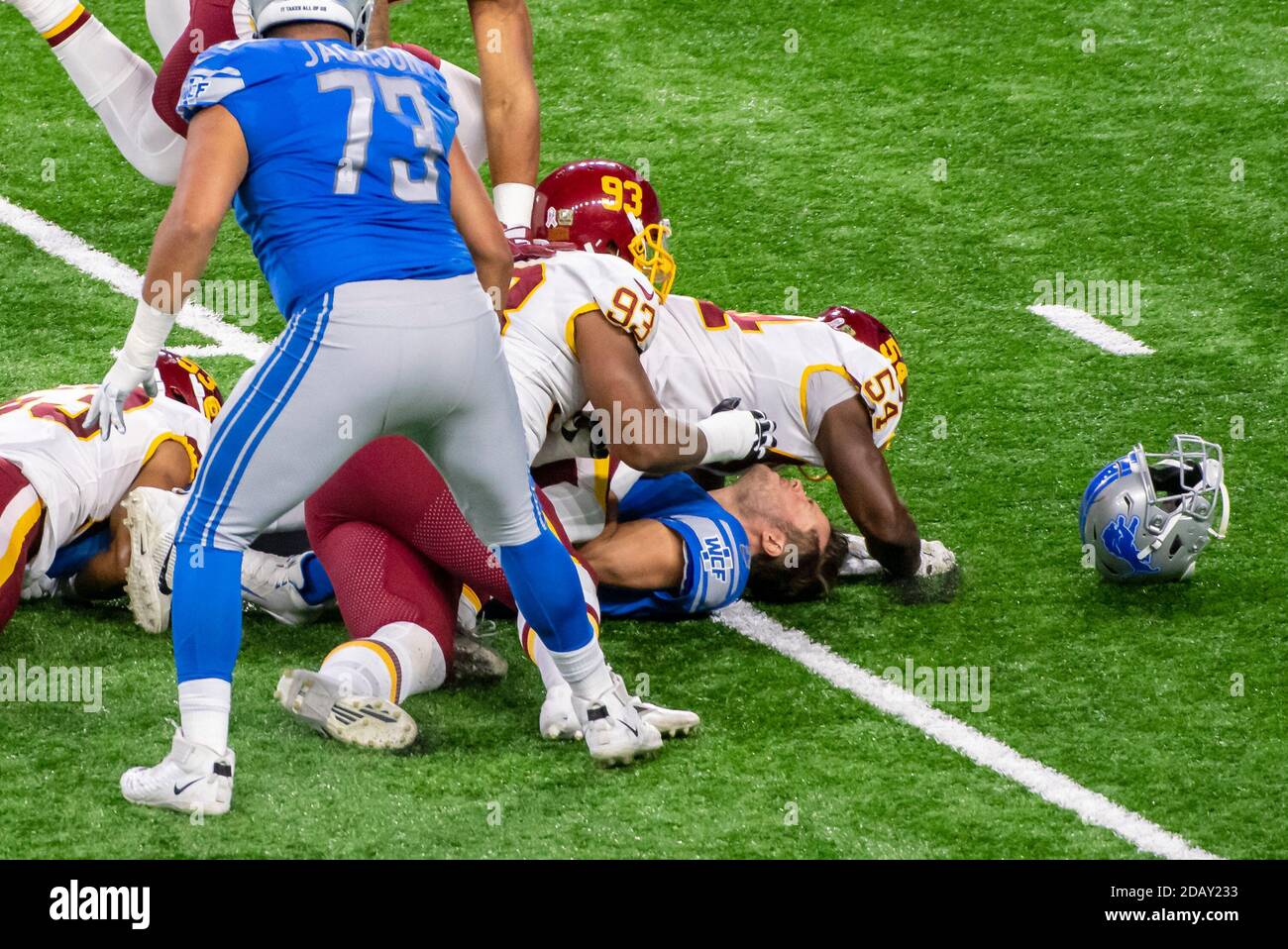 DETROIT, MI - NOVEMBER 15: Detroit Lions QB Matthew Stafford (9) has his helmet knocked off by the tackle from Washington Football Team LB Kevin Pierre-Louis (54) during NFL game between Washington Football Team and Detroit Lions on November 15, 2020 at Ford Field in Detroit, MI (Photo by Allan Dranberg/Cal Sport Media) Stock Photo