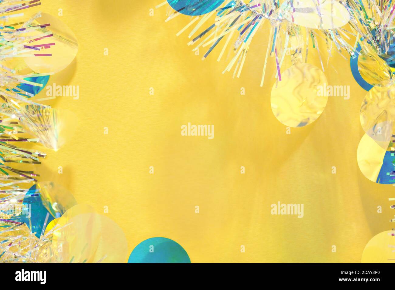 Christmas tinsel garland frame yellow background with copy space Stock