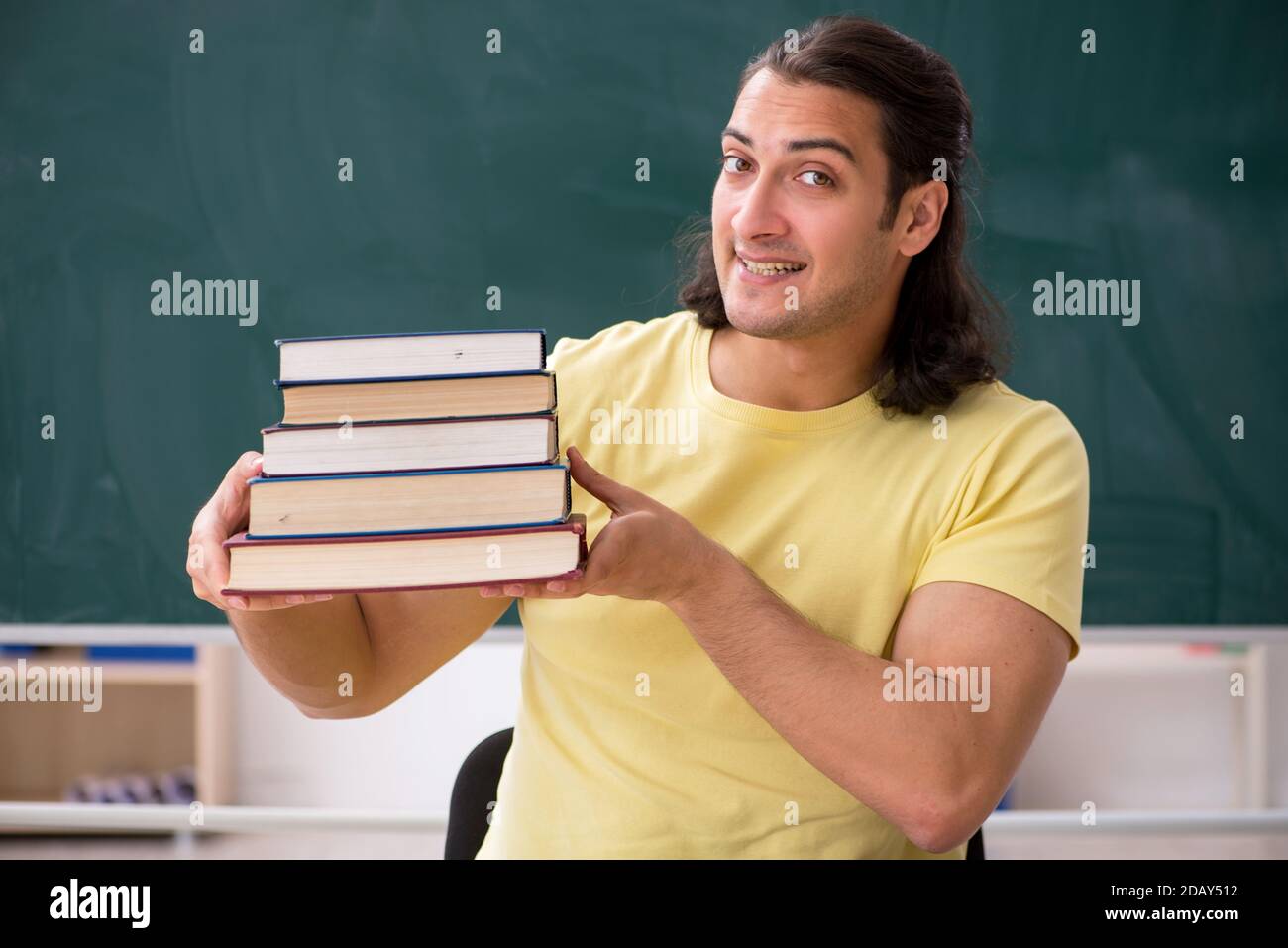 Young student preparing for exams in the classroom Stock Photo - Alamy