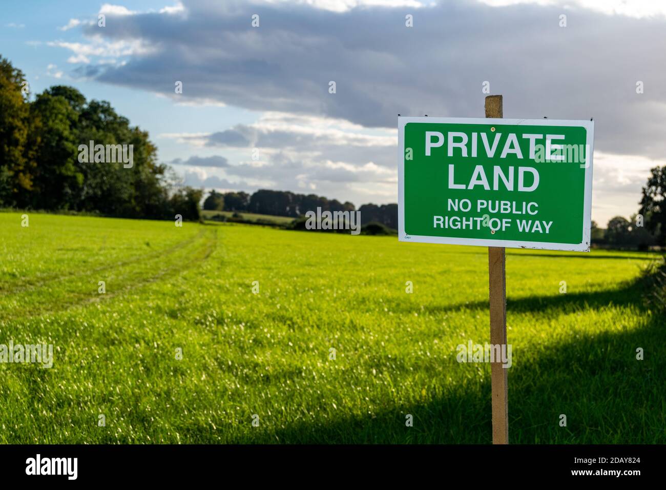 Private land no public right of way saying sign, beautiful and inviting lush open grassland behind, farmers taking lands and prohibit the entry Stock Photo