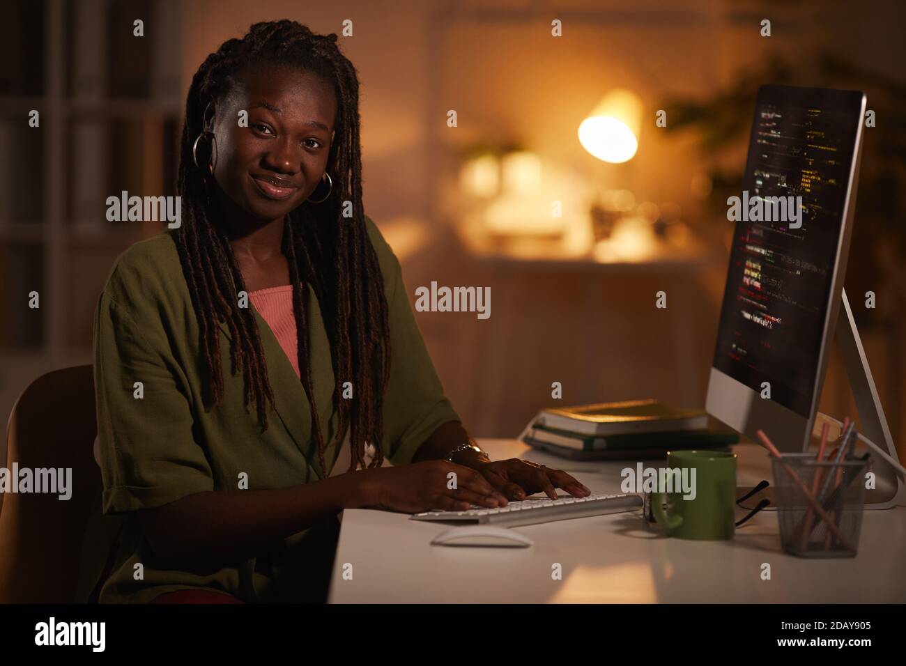 Portrait of contemporary African-American woman writing code and ...