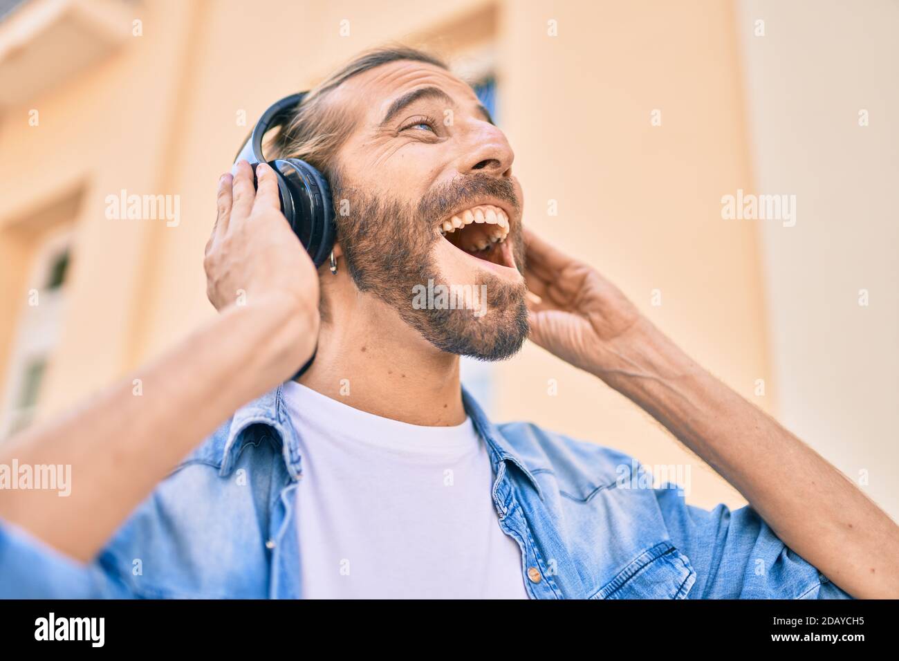 Young middle eastern man smiling happy using headphones at the city ...