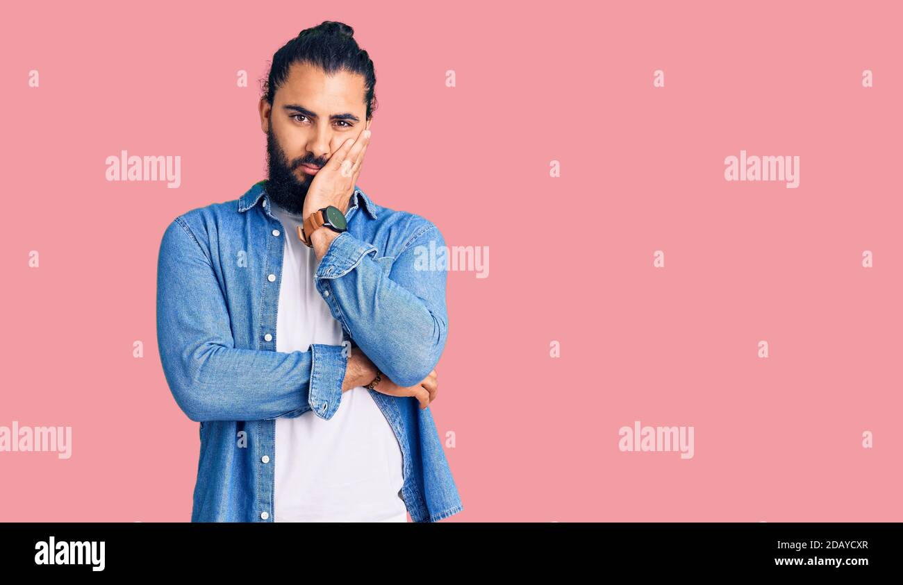 Young arab man wearing casual denim shirt thinking looking tired and ...