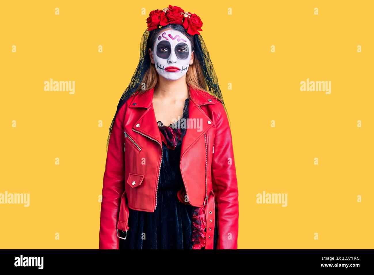 Woman wearing day of the dead costume over background depressed