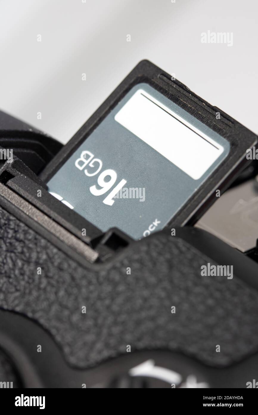 The memory card in camera slot. The memory card inserted to card hole in open door of the digital camera. Stock Photo