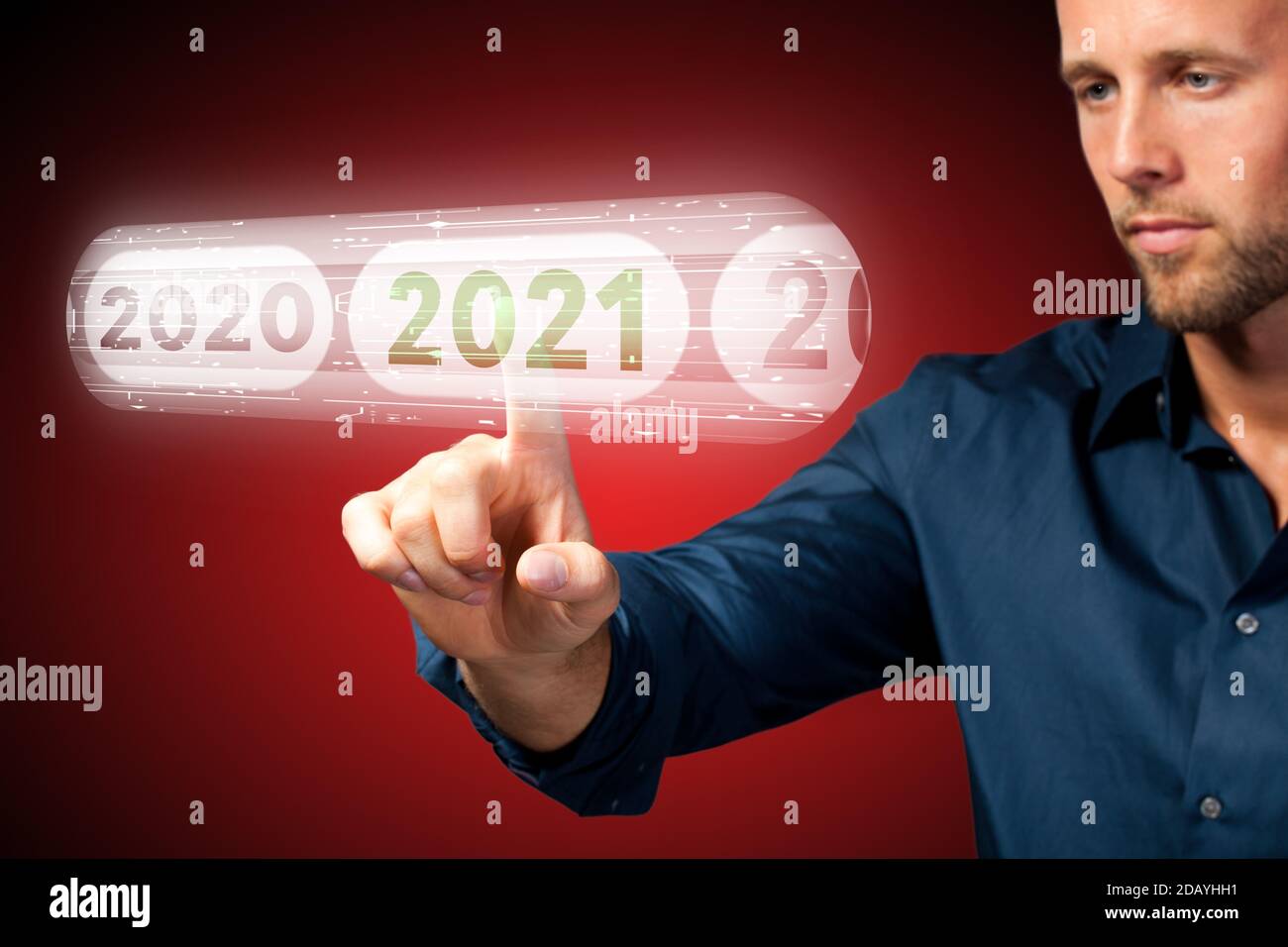 man is using virtual interface to select 2021 on red background Stock Photo