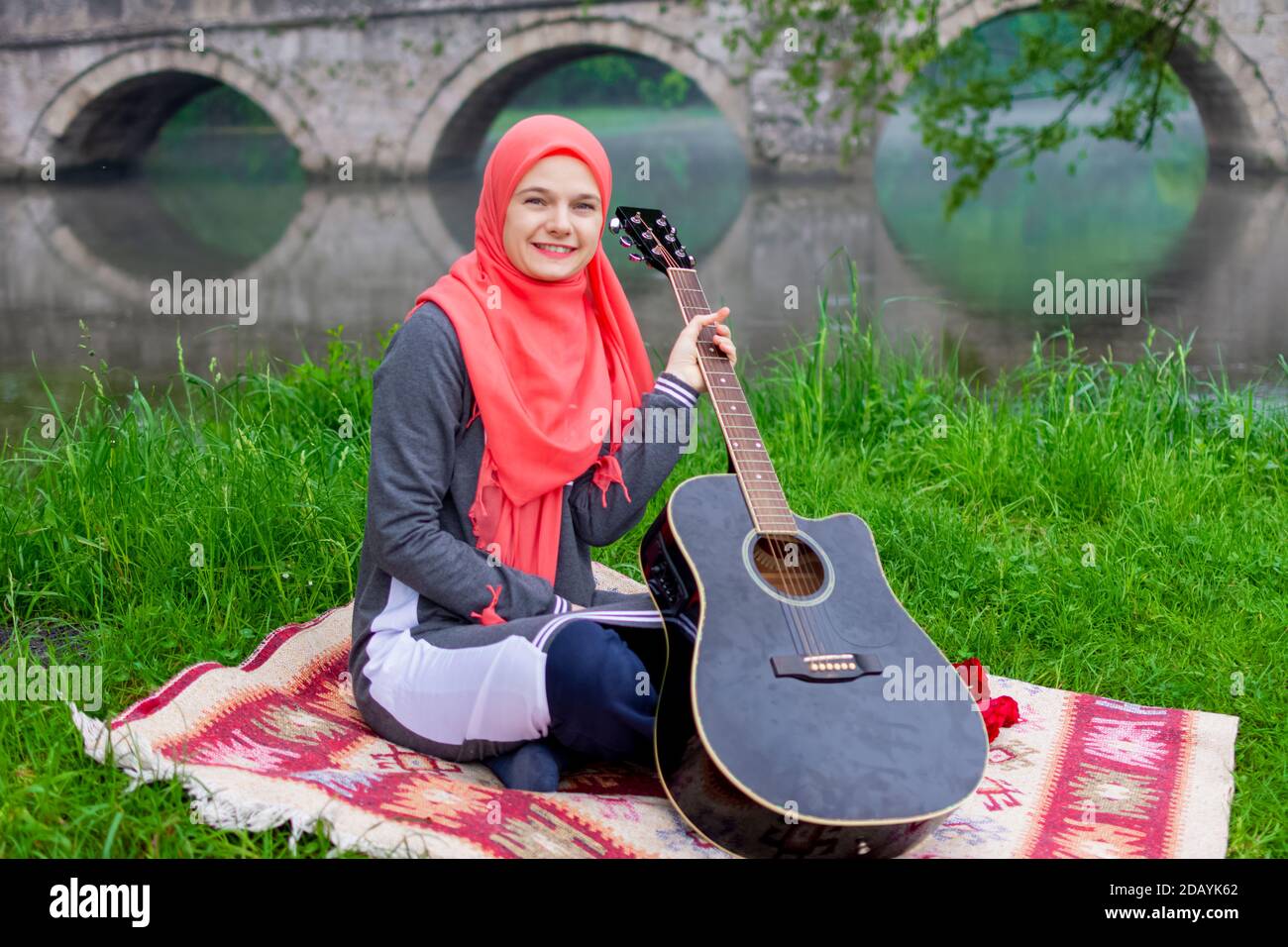 Portrait of muslim girl holding acoustic guitar Stock Photo - Alamy