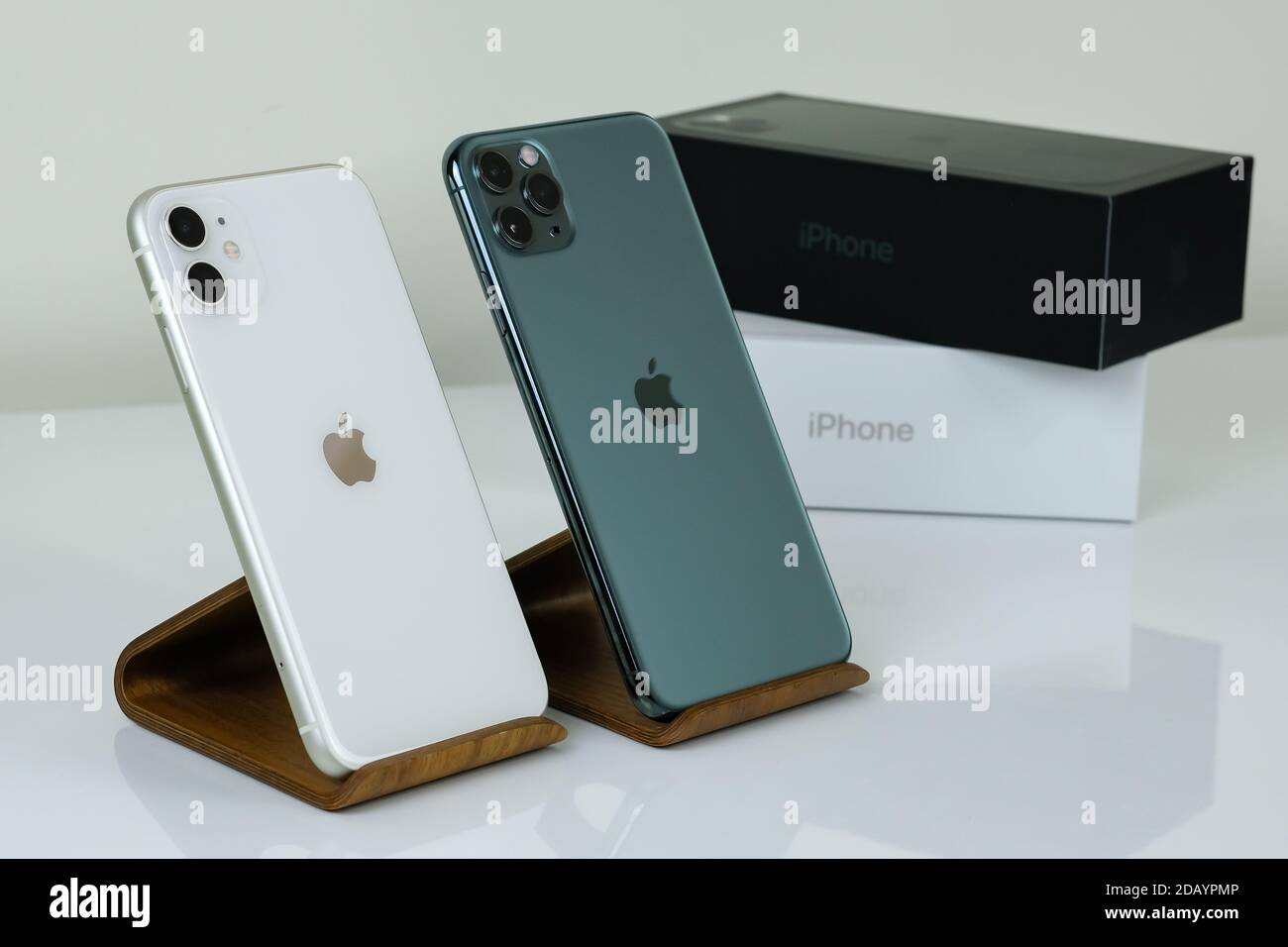iPhone 11 Pro Max in midnight green next to iPhone 11 in white
