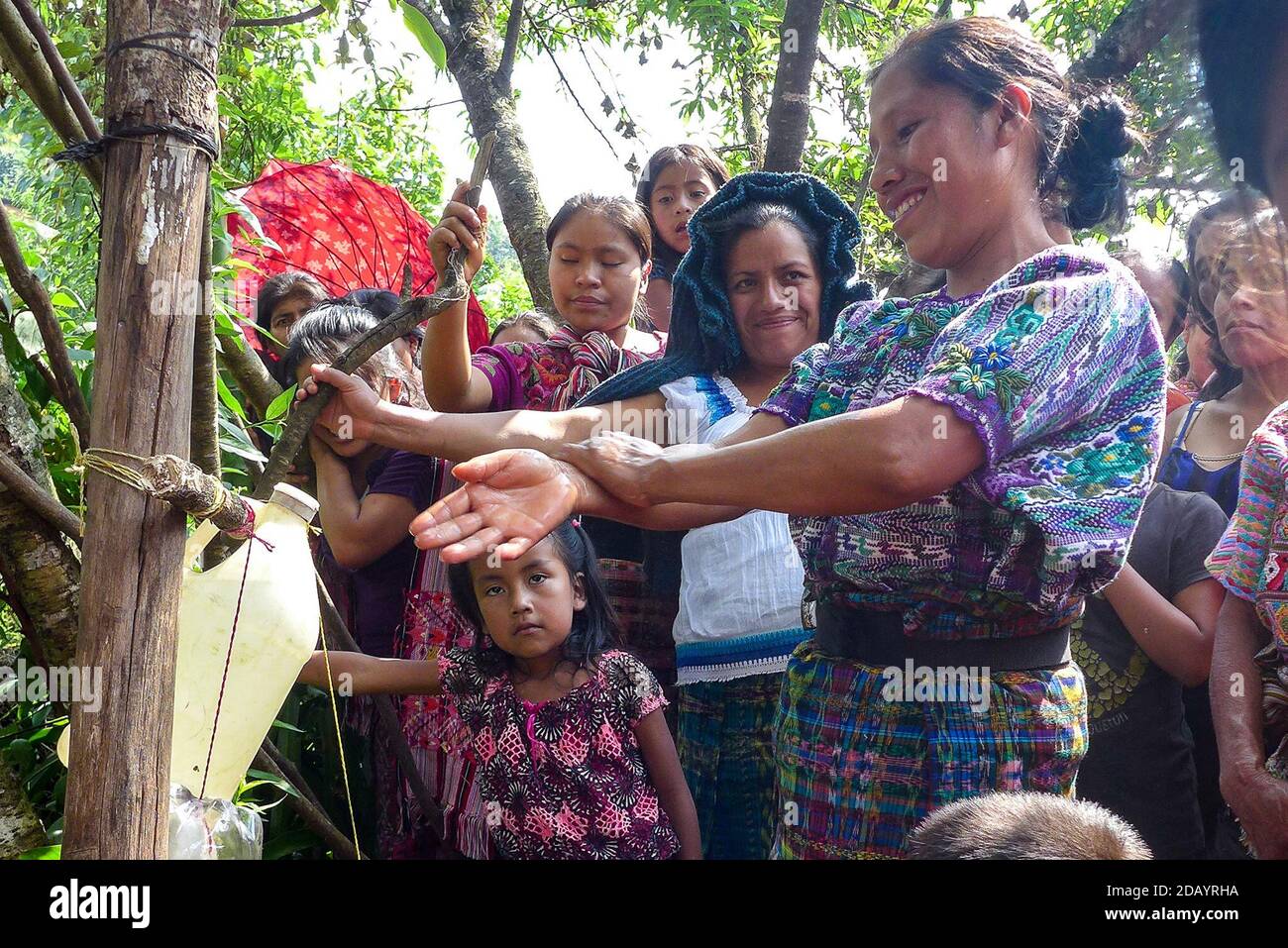 Ana Pérez Gómez experiments with cost-effective hand washing techniques during a lesson on water-conserving hand-washing methods in San Juan Cotzal, a town in El Quiché (CQ LINK), Guatemala. The lesson was a part of PAISANO, a 6-year food security project in Guatemala by the non-profits Save the Children (CQ LINK) and Project Concern International (CQ LINK). (Brenda Leticia Saloj Chiyal, GPJ Guatemala) Stock Photo