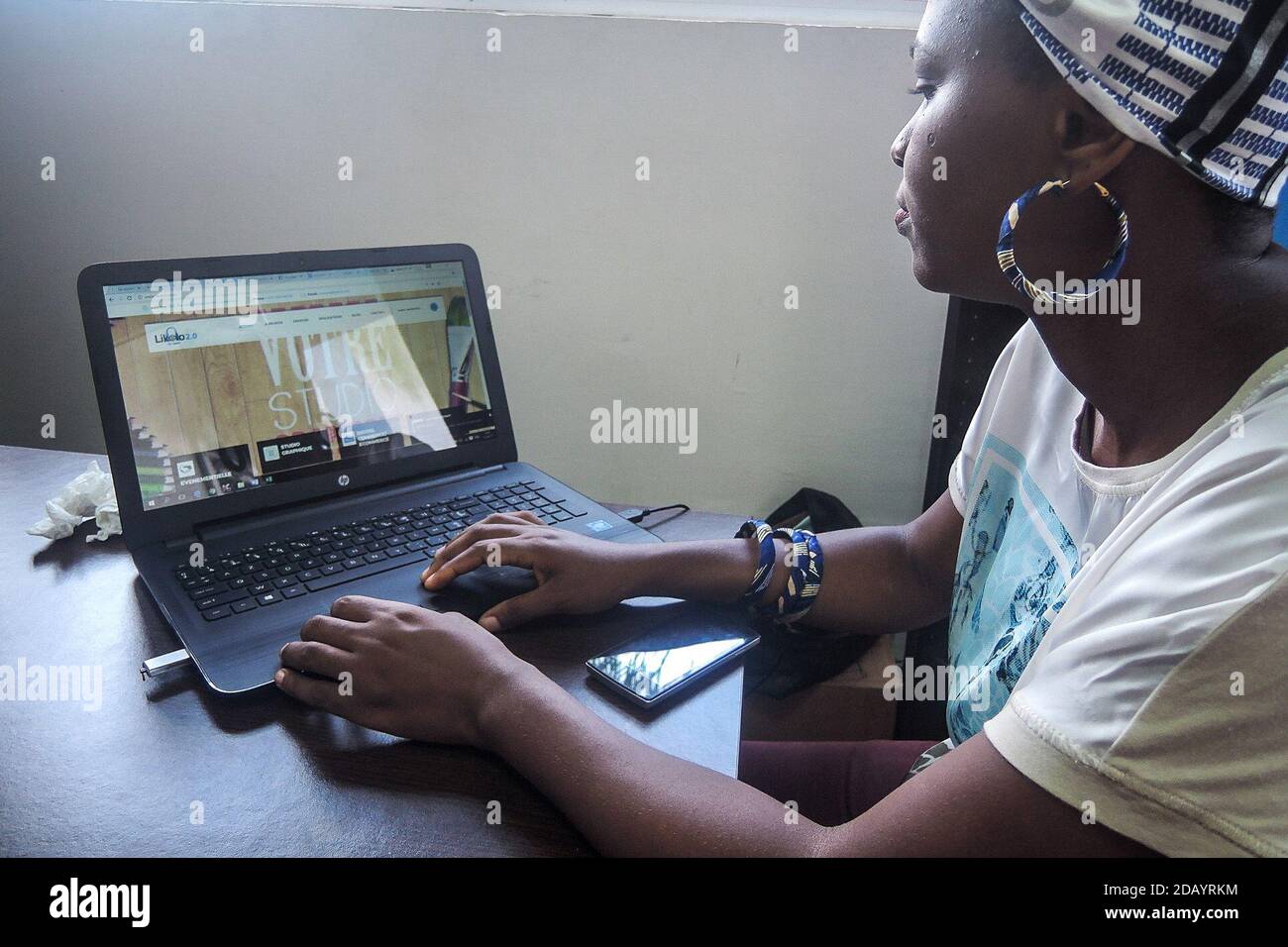 A woman works on her HP computer at a co-working space in Douala, Cameroon. Stock Photo