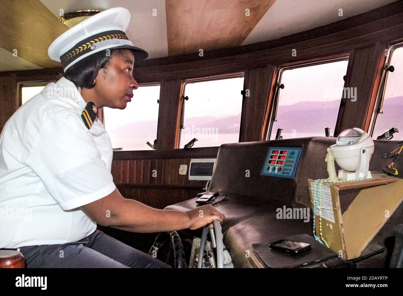 A female captain skippers a boat across Lake Kivubetween Goma and