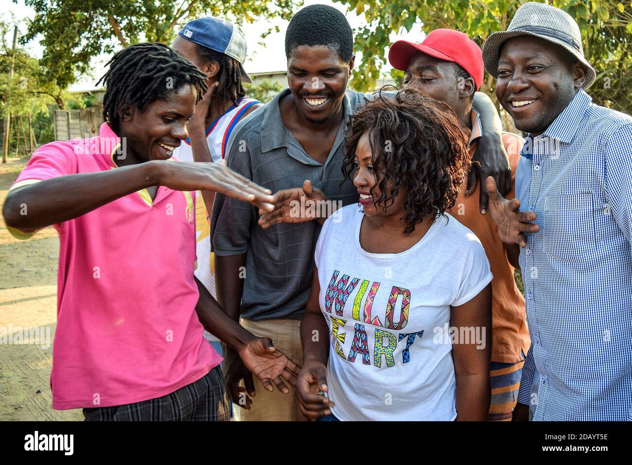 Fans greet Sandra Gazi, a Zim-dancehall artist known by her stage name Lady Squanda, outside of Tyger Records recording studio in Mabvuku, Zimbabwe. Stock Photo