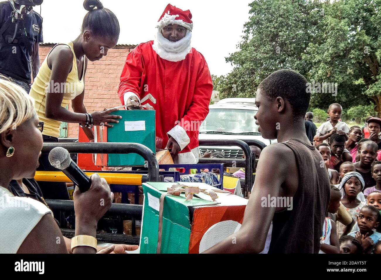 Children gather to see Santa Claus and receive gifts during the event “Santa Comes to Makokoba,” at the Thabiso Youth Centre in Bulawayo, Zimbabwe Stock Photo