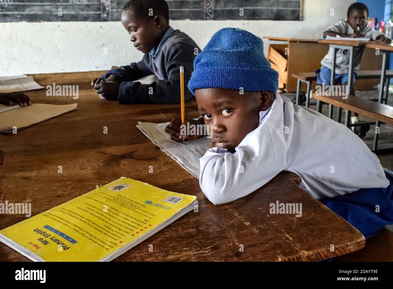 A student works at his desk at school in Goromonzi, Zimbabwe. Schools in Zimbabwe are chronically underfunded and sometimes don't have enough teachers Stock Photo